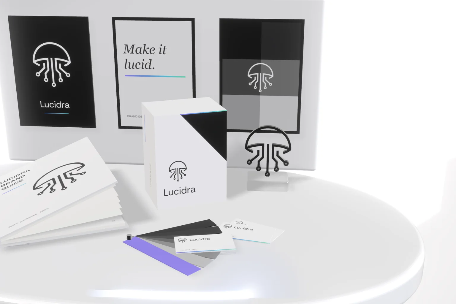 Lucidra brand materials on a white table: posters, a guide, a box, business cards, a grey colour fan and a jellyfish sculpture